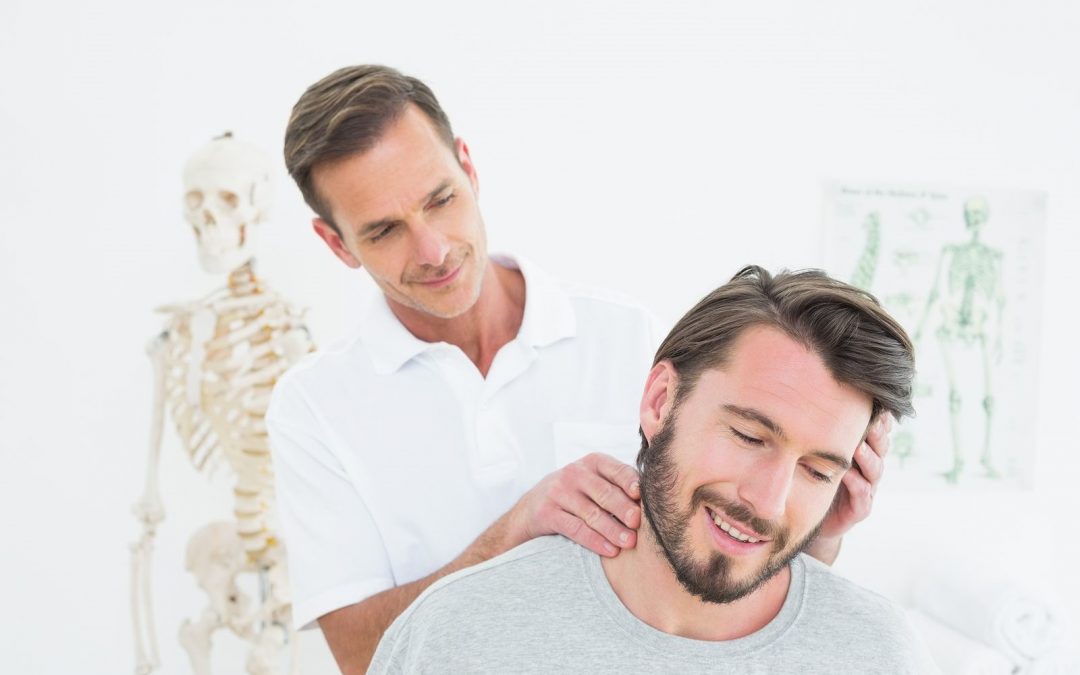 chiropractor massaging a patient on the neck