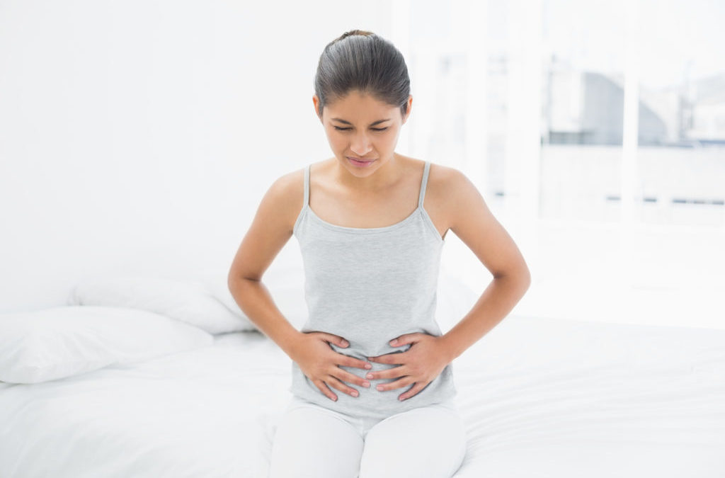 woman holding her stomach from menstrual cramp
