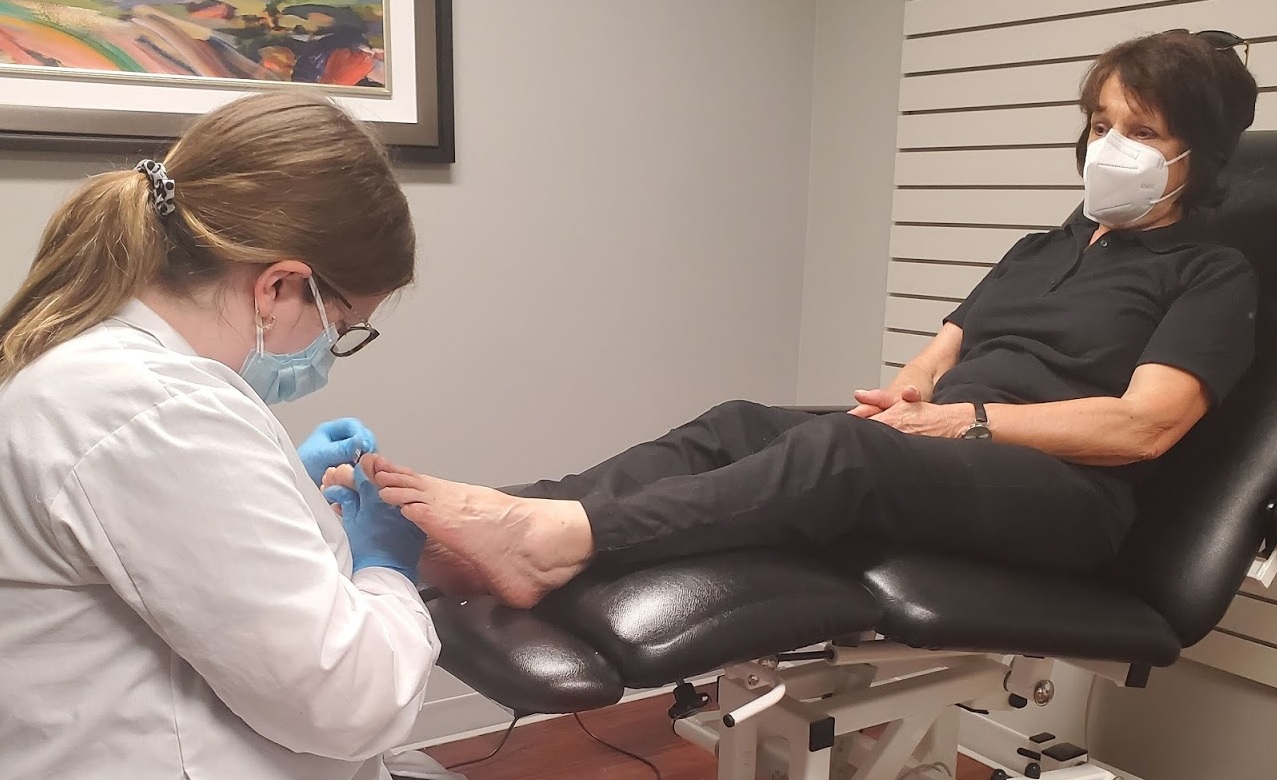 wefixu chiropodist treating the foot of a patient who is sitting on a chair