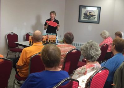 wefixu staff explaining physiotherapy technique to group of elderly