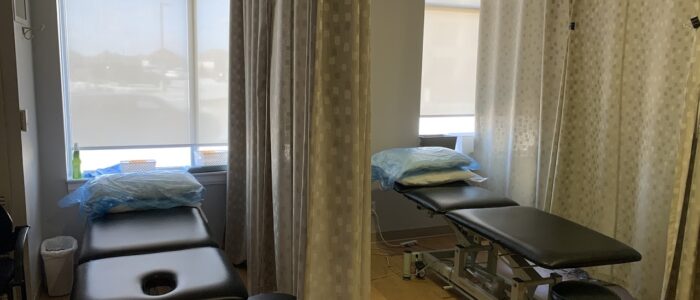 Oshawa treatment room with two beds and curtains